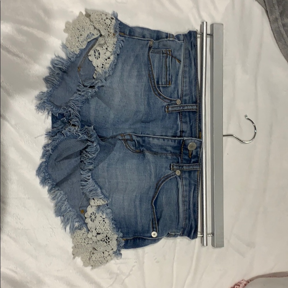 Light wash shorts with design on the sides